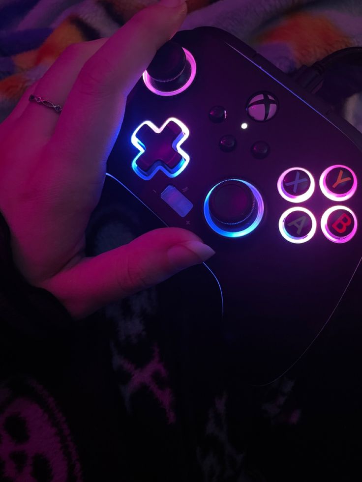 a rainbow backlit xbox controller that is in the color black