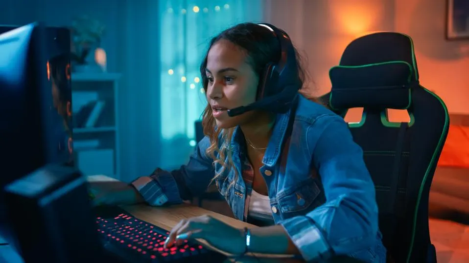 a woman playing videogames with headphones on
